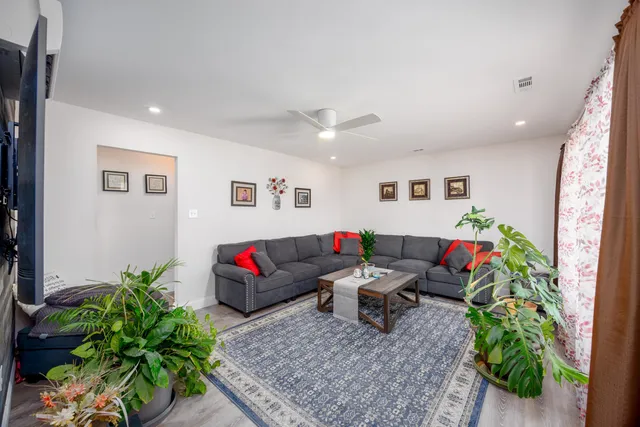 a living room with furniture potted plant and a window