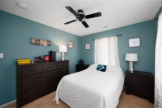 a bedroom with a bed and a desk