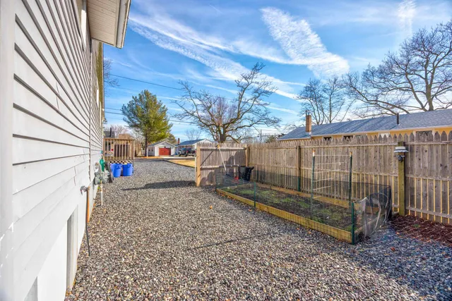 a view of a backyard with a tree