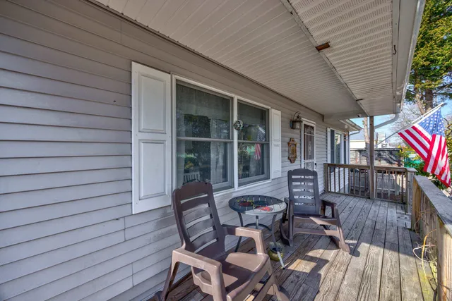 a view of a patio with table and chairs with wooden floor and plants