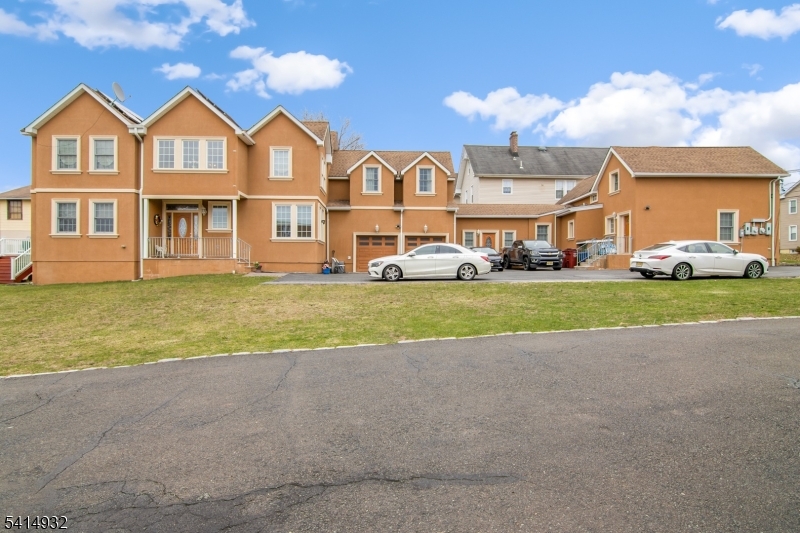a view of a big yard in front of a brick house with a big yard