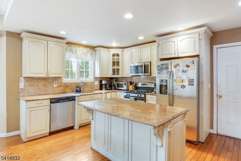 36 Harrison Street Nutley, NJ 07110 - Photo 13 of 36 a kitchen with stainless steel appliances granite countertop a sink stove and refrigerator