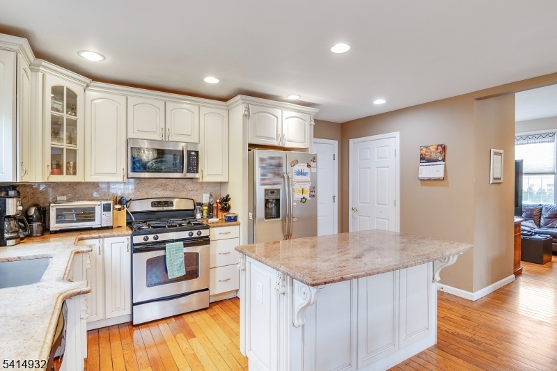 36 Harrison Street Nutley, NJ 07110 - Photo 15 of 36 a kitchen with stainless steel appliances granite countertop a sink stove and refrigerator
