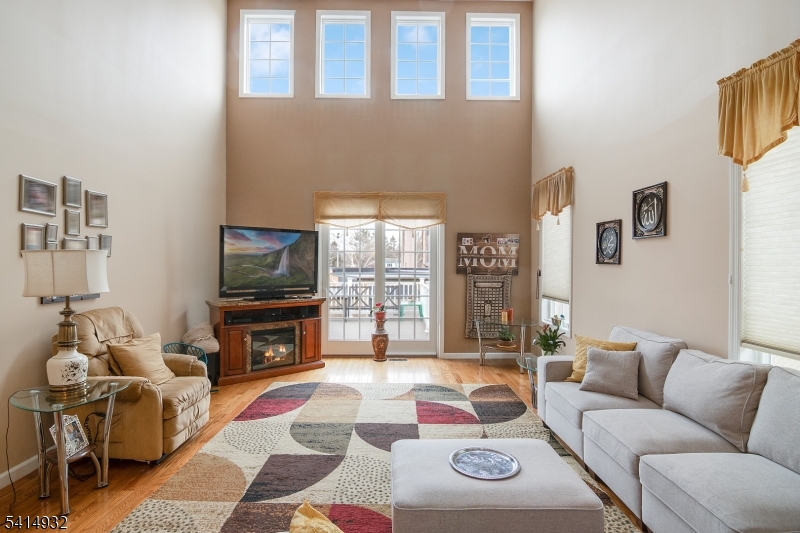 36 Harrison Street Nutley, NJ 07110 - Photo 18 of 36 a living room with furniture a flat screen tv and a fireplace
