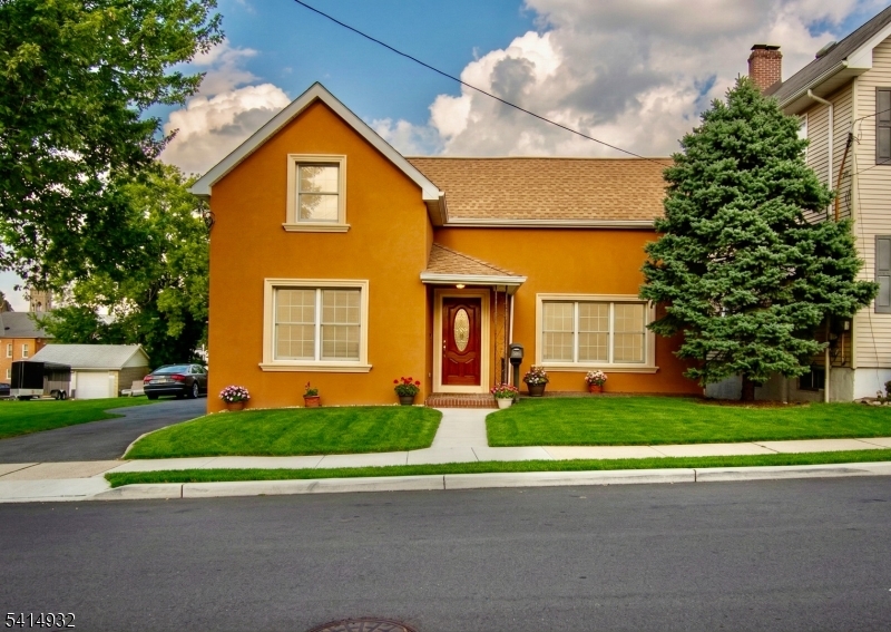 36 Harrison Street Nutley, NJ 07110 - Photo 2 of 36 a front view of a house with a yard and garage