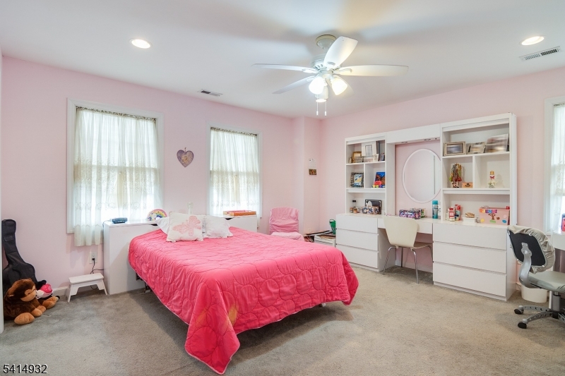 36 Harrison Street Nutley, NJ 07110 - Photo 21 of 36 a bedroom with a bed and a chandelier