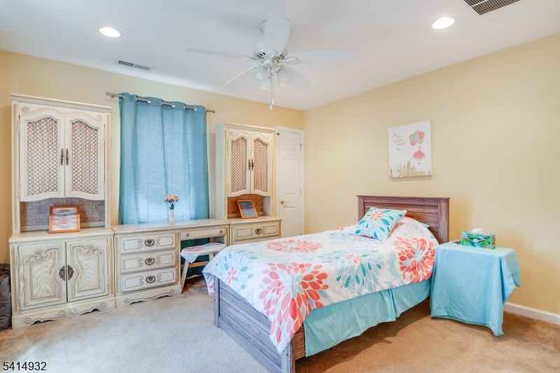 36 Harrison Street Nutley, NJ 07110 - Photo 25 of 36 a bedroom with a bed and a chandelier