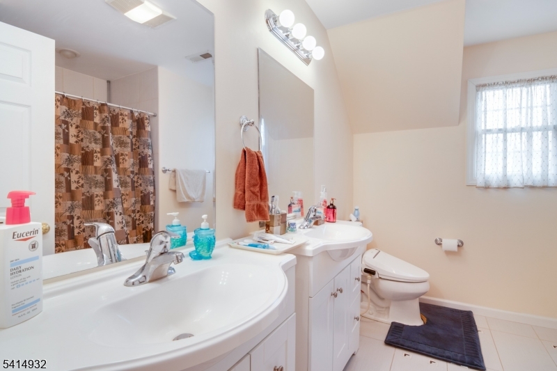 36 Harrison Street Nutley, NJ 07110 - Photo 26 of 36 a bathroom with a sink vanity mirror and toilet