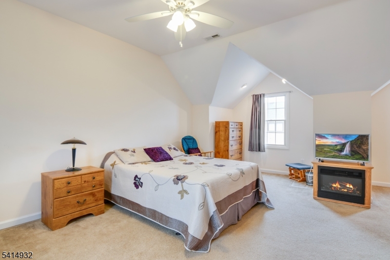 36 Harrison Street Nutley, NJ 07110 - Photo 27 of 36 a bedroom with a bed and a fireplace