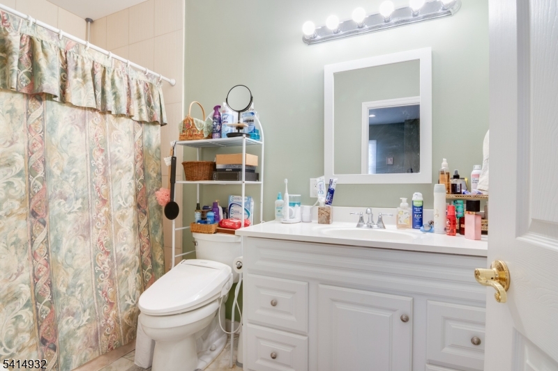 36 Harrison Street Nutley, NJ 07110 - Photo 33 of 36 a bathroom with a sink vanity mirror and toilet