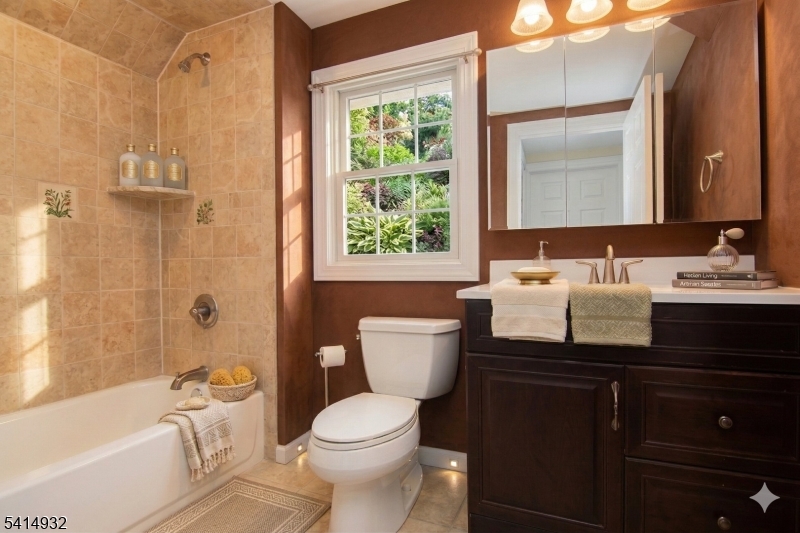 36 Harrison Street Nutley, NJ 07110 - Photo 7 of 36 a bathroom with a sink a toilet and shower