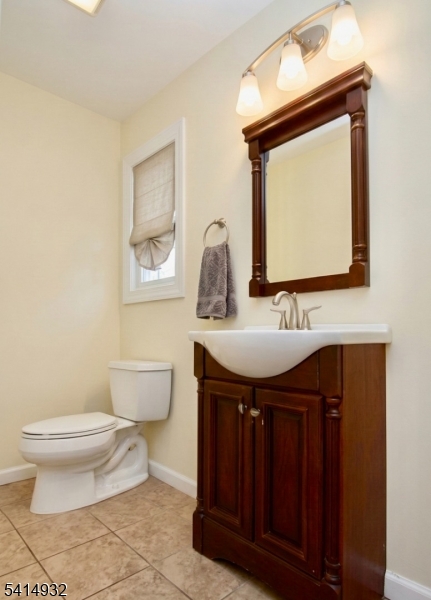 36 Harrison Street Nutley, NJ 07110 - Photo 8 of 36 a bathroom with a toilet sink and mirror