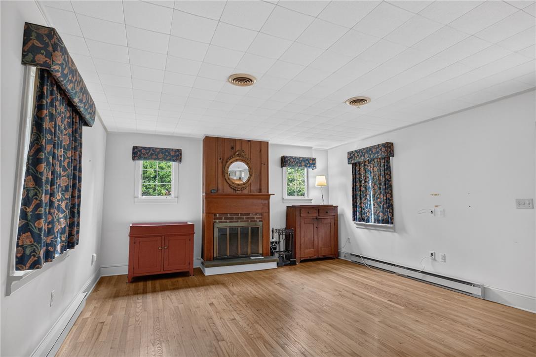 765 East Macada Road Bethlehem, PA 18017 - Photo 23 of 46 A classic brick fireplace with wood surround anchors this naturally illuminated living area with gleaming hardwood floors.