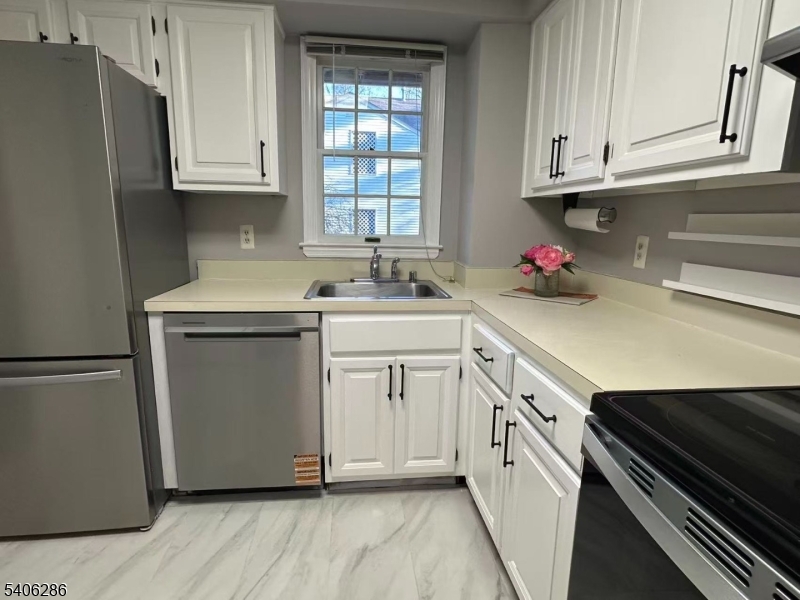 95 Jamestown Road, Unit 95 Bernards, NJ 07920 - Photo 11 of 17 a kitchen with granite countertop white cabinets and white appliances