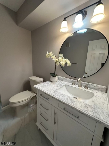 95 Jamestown Road, Unit 95 Bernards, NJ 07920 - Photo 2 of 17 a bathroom with a granite countertop sink and a mirror