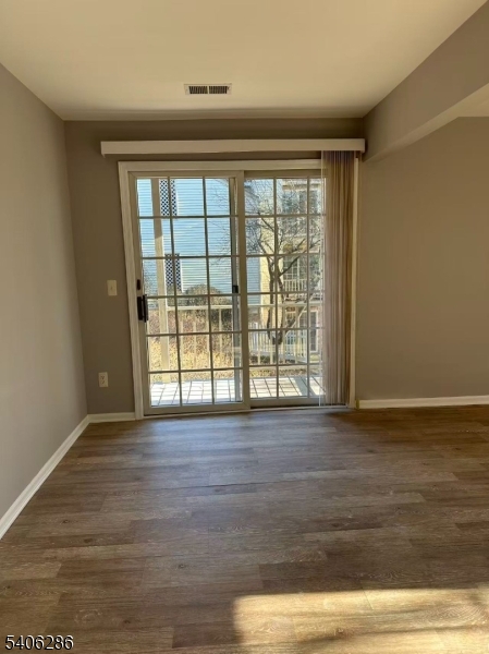 95 Jamestown Road, Unit 95 Bernards, NJ 07920 - Photo 9 of 17 a view of an empty room with wooden floor and a window