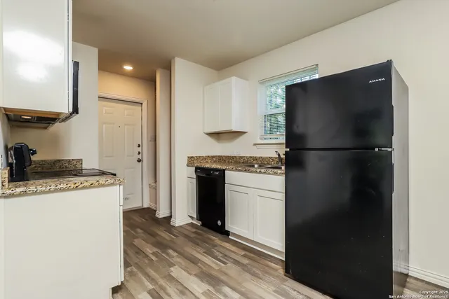 a kitchen with a refrigerator and a stove