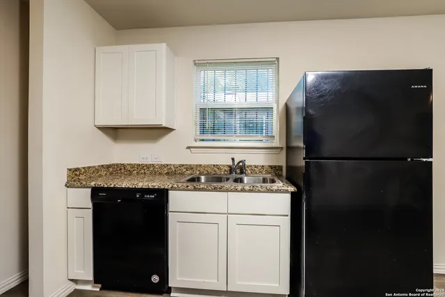 a kitchen with a sink and a refrigerator