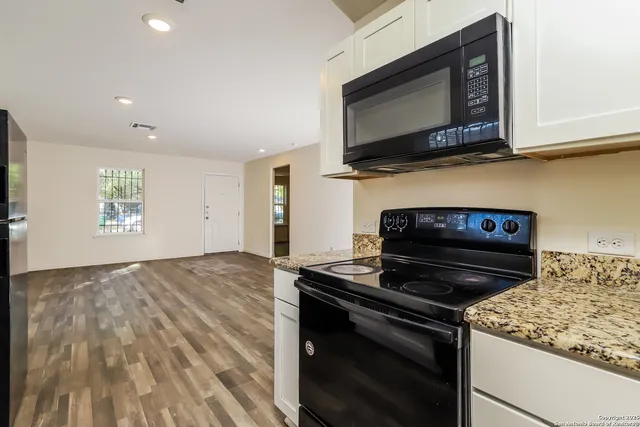 a kitchen with a stove and a microwave