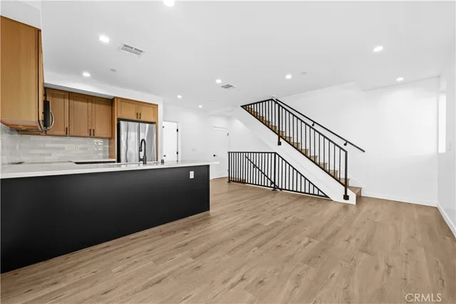 a living room with furniture and kitchen view