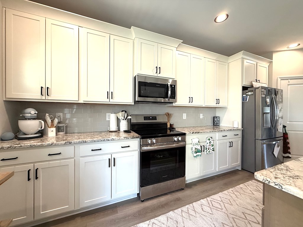 33 Sugar Maple Drive Fort Mitchell, AL 36856 - Photo 10 of 29 a kitchen with stainless steel appliances granite countertop a stove a sink and a refrigerator
