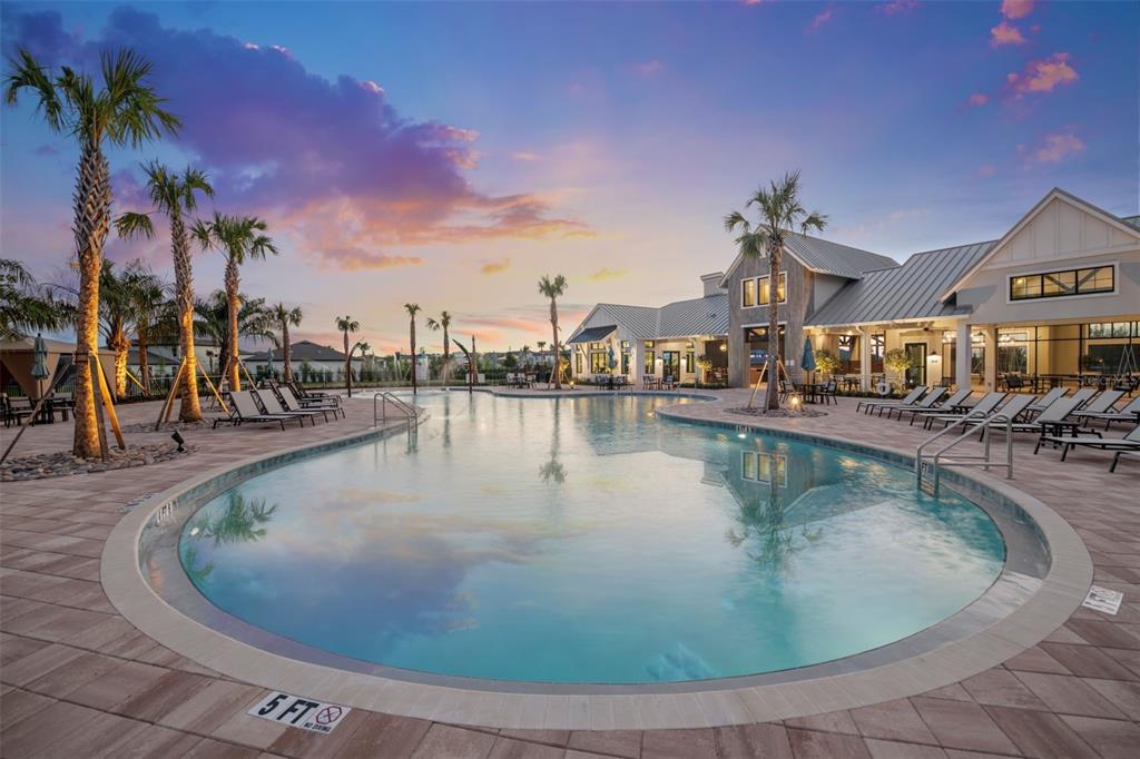6888 Gilly Shadow Street Wesley Chapel, FL 33545 - Photo 35 of 46 a view of a swimming pool with outdoor seating