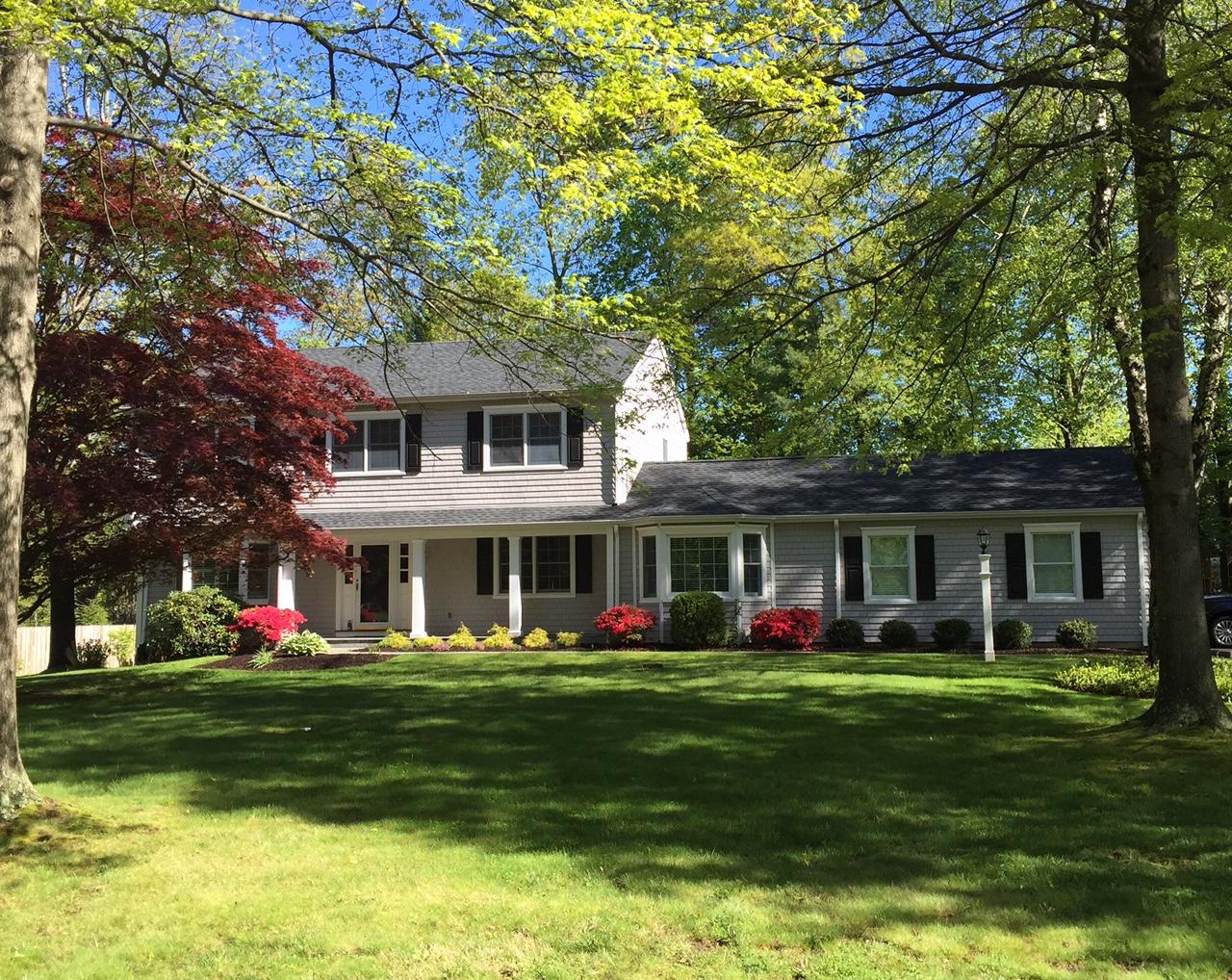 27 Summit Ridge Road New Canaan, CT 06840 - Photo 1 of 25 a front view of house with yard and green space