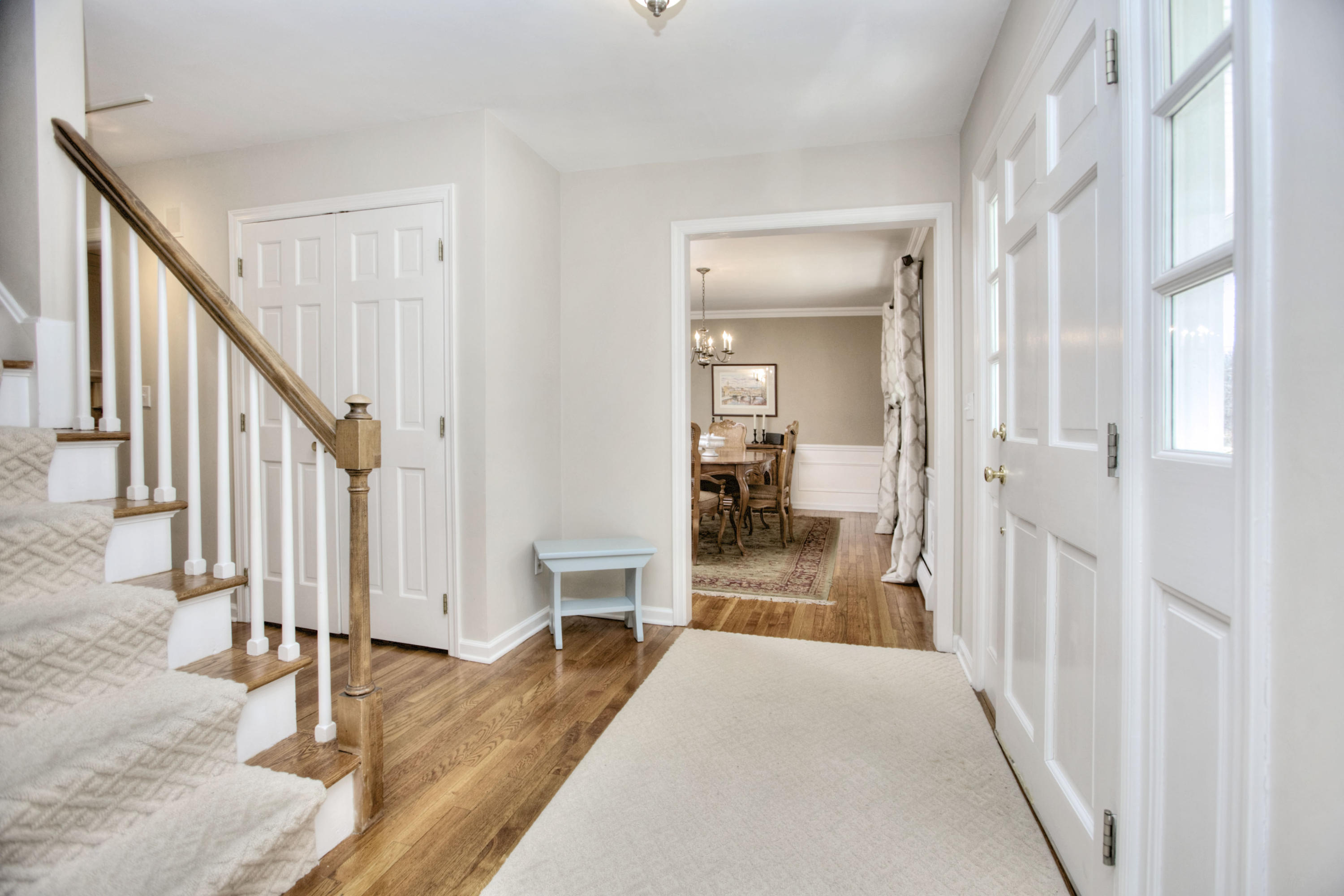 27 Summit Ridge Road New Canaan, CT 06840 - Photo 2 of 25 a view of a hallway with wooden floor and staircase