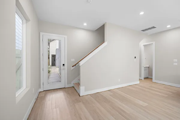 wooden floor in an empty room with a window
