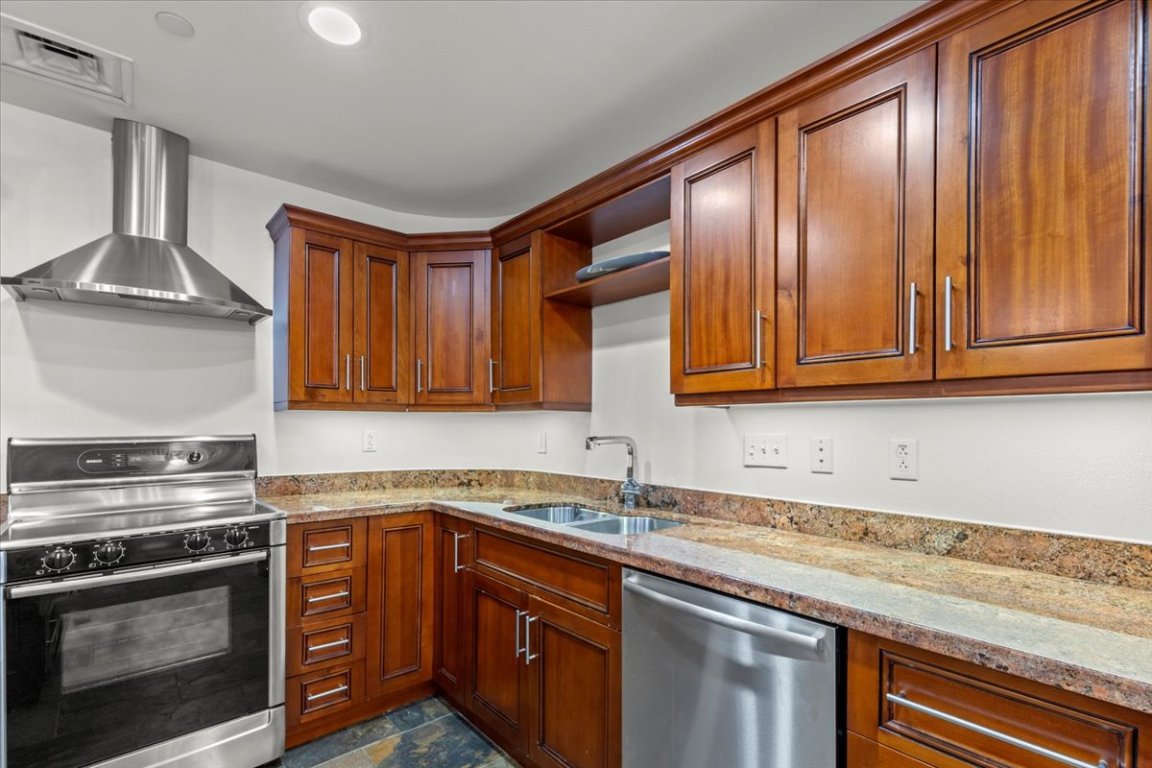1812 West Avenue, Unit 306 Austin, TX 78701 - Photo 15 of 38 Kitchen with range with electric cooktop, dishwasher, a sink, visible vents, and wall chimney exhaust hood