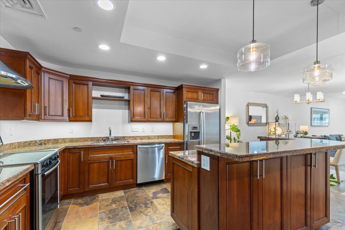 1812 West Avenue, Unit 306 Austin, TX 78701 - Photo 17 of 38 Kitchen with recessed lighting, a sink, a center island, stone finish floor, and appliances with stainless steel finishes