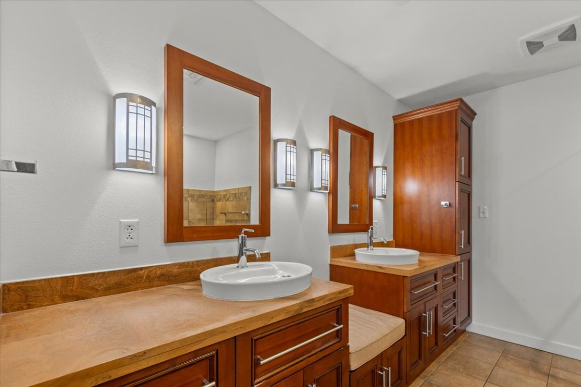 1812 West Avenue, Unit 306 Austin, TX 78701 - Photo 30 of 38 Full bathroom with visible vents, two vanities, tile patterned flooring, and a sink