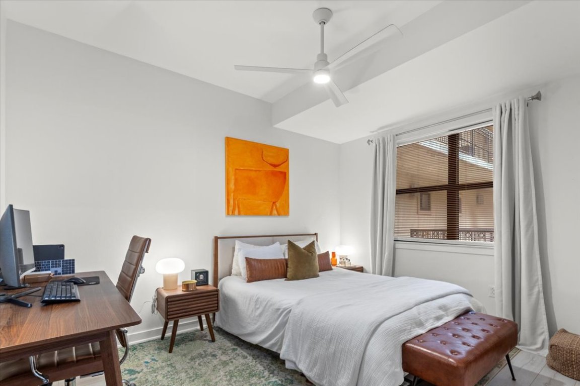 1812 West Avenue, Unit 306 Austin, TX 78701 - Photo 34 of 38 Bedroom featuring ceiling fan and baseboards