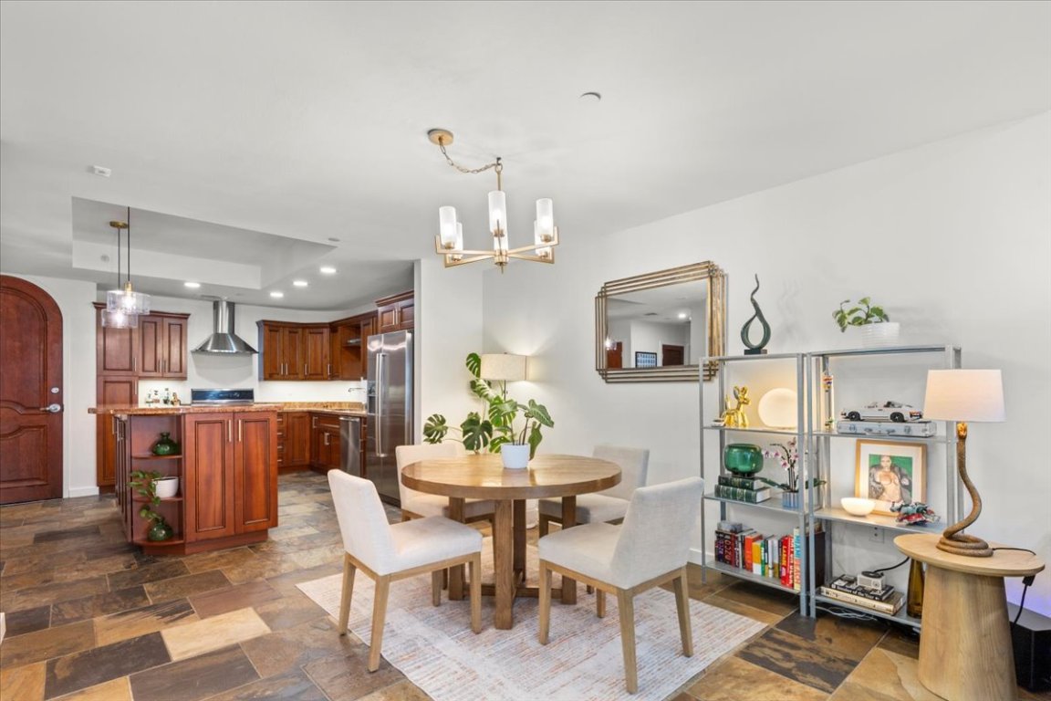 1812 West Avenue, Unit 306 Austin, TX 78701 - Photo 6 of 38 Dining room featuring stone finish flooring, recessed lighting, and a notable chandelier