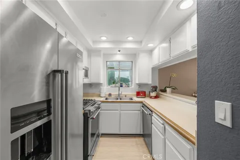 a kitchen with sink a stove and cabinets