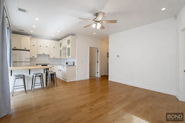 a view of kitchen with kitchen island and stainless steel appliances