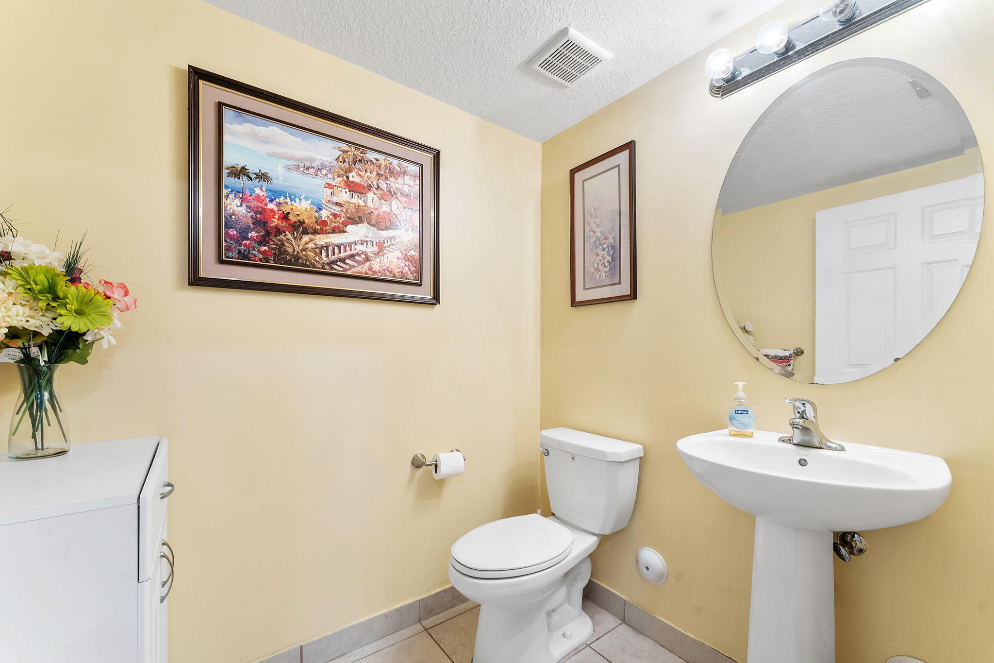 5438 Northwest 27th Street Margate, FL 33063 - Photo 35 of 50 a bathroom with a toilet sink and mirror