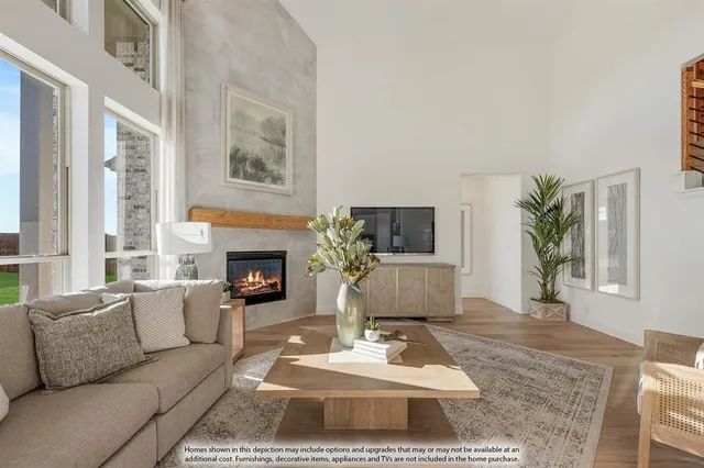 a living room with furniture a rug a fireplace and a large window