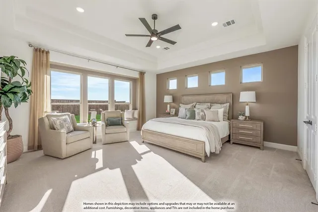 a bedroom with a large bed couch and a large window