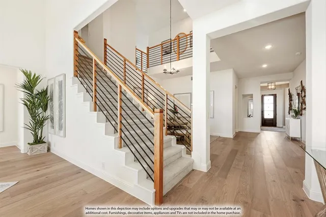 a view of a hallway with wooden floor and stairs
