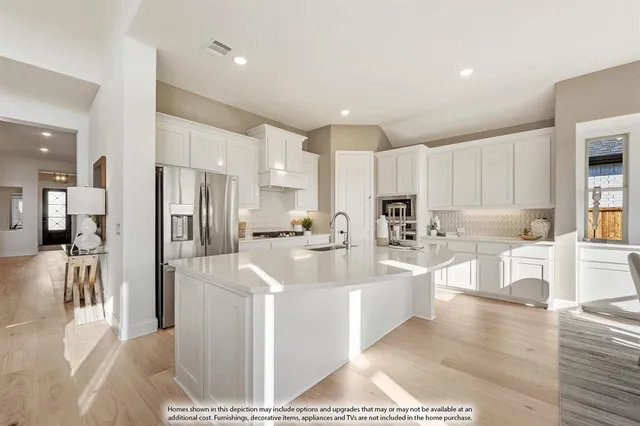 a large white kitchen with cabinets a sink and a counter top space