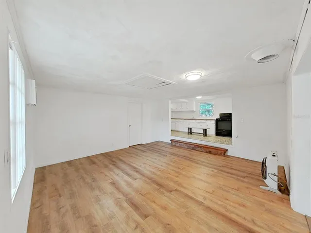 a view of a kitchen with a sink and a refrigerator