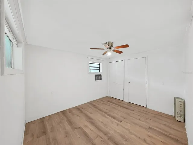a view of a room with wooden floor