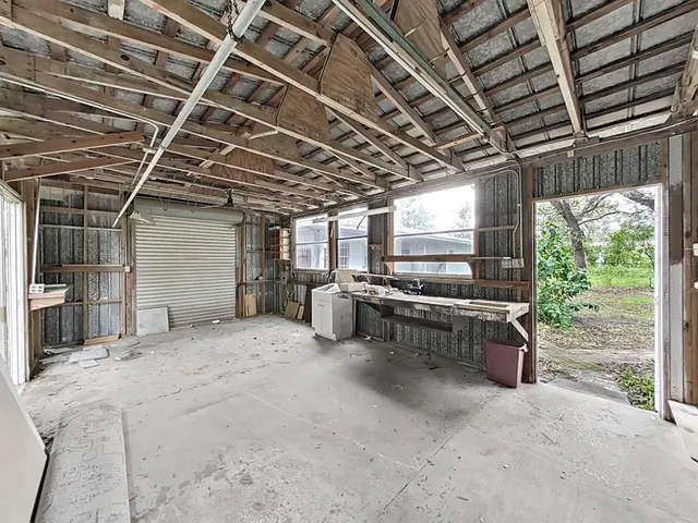 a view of a room with wooden ceiling