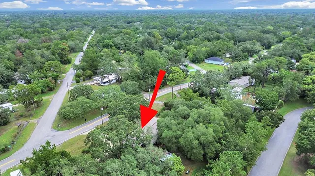 an aerial view of residential houses with outdoor and green space