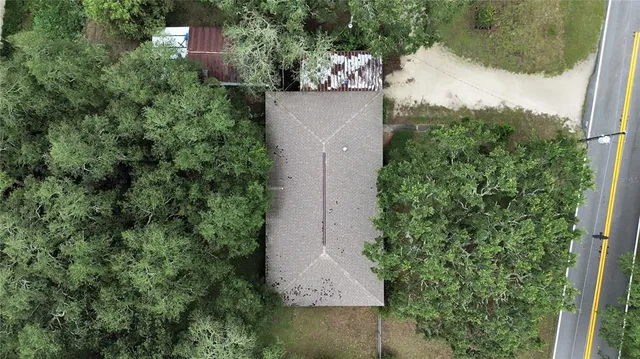 an aerial view of a house with a yard and garden