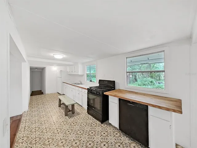 a kitchen with a stove a refrigerator and a sink