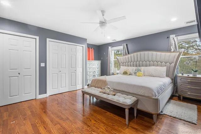 a bed sitting in a bedroom next to a window