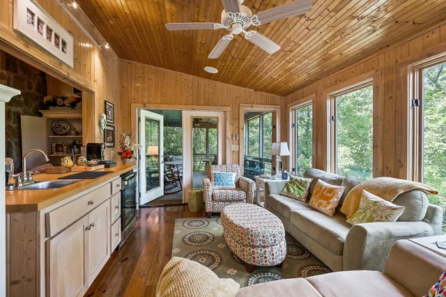 a bedroom with a bed a dresser next to a window