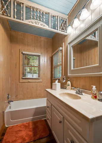 a view of an empty room with wooden floor and furniture